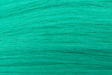 Green curly long hair close-up. A wave of hair as a background