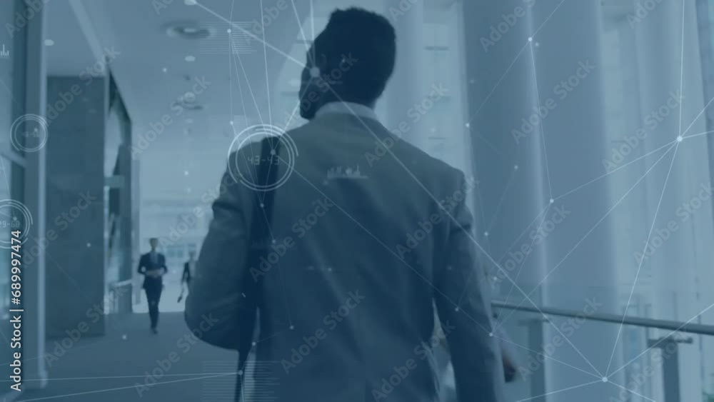 Wall mural Animation of network of connections over african american businessman walking in office