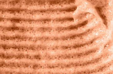 A smear of scrub. The concept of beauty. Color peach fuzz