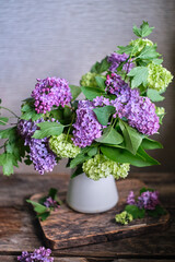 bouquet of lilac flowers. Wooden background, side view