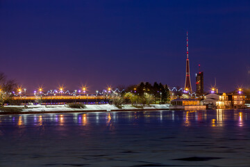 View of the city of Riga, the capital of Latvia, during the blue hour of a winter night. The TV tower stands out in the skyline