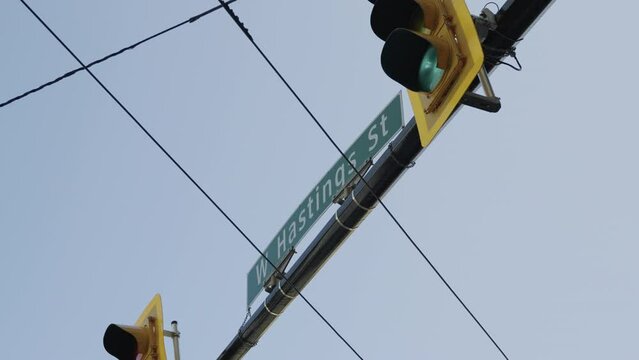 West Hastings in Vancouver street sign at the crossing, handheld parallax, slow motion