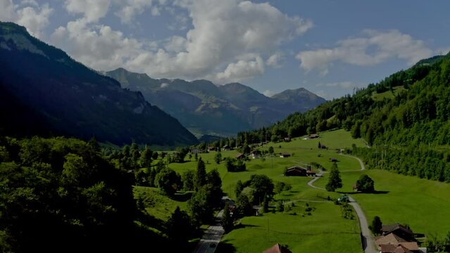 The drone is going to the upper side where there are many low rise houses on top of the mountains Gasthof zur Einkehr.