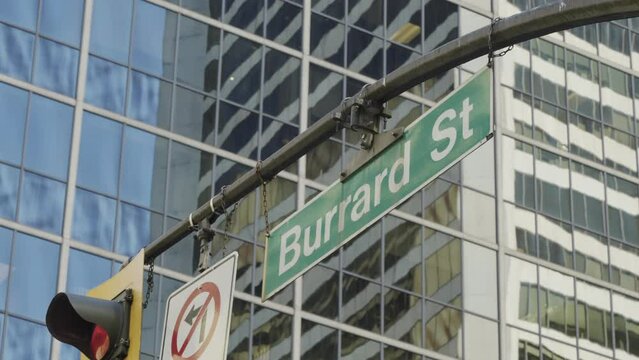 Burrard Street crossing in Vancouver, street sign with buildings in the background, handheld parallax.