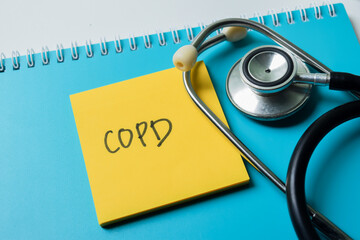 Concept of COPD write on sticky notes with stethoscope isolated on white background.