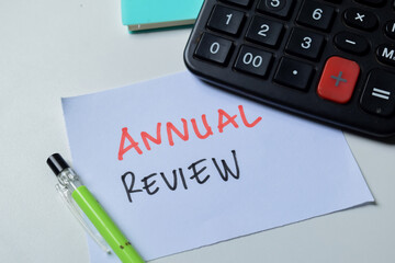 Concept of Annual Review write on sticky notes isolated on white background.