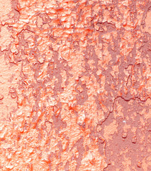 Cracked rusty metal painted with red paint as an abstract background. Texture