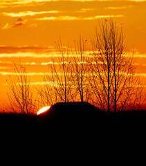 The sun rises on the horizon in the village