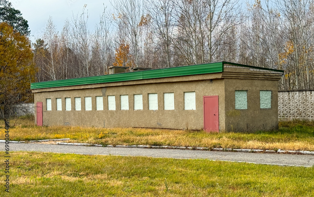 Wall mural Green building in nature outside the city