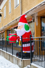 Big inflated Santa Claus standing outsid shop