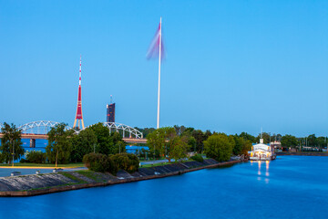 A view of Riga skyline at blue hour, featuring the large flagpole and the TV tower, the tallest structure in the European Union. Riga is known for its historic center and its Art Nouveau architecture
