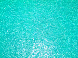 Fototapeta na wymiar Aerial top view of a beautiful island, stunning ocean, crystal clear water, tropical paradise in the Maldives. Aerial top-down drone view.