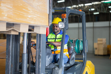 Worker driver at warehouse forklift loader works to containers box, worker man in warehouse with...