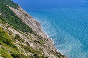Fototapeta na wymiar Sheer mountain slopes to the Black Sea coast in Anapa