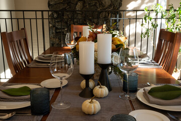 Festive Thanksgiving tablescape, with candles and flowers.