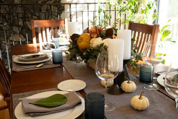 Festive Thanksgiving tablescape, with candles and flowers.
