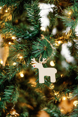 Handmade reindeer ornament on twinkling tree