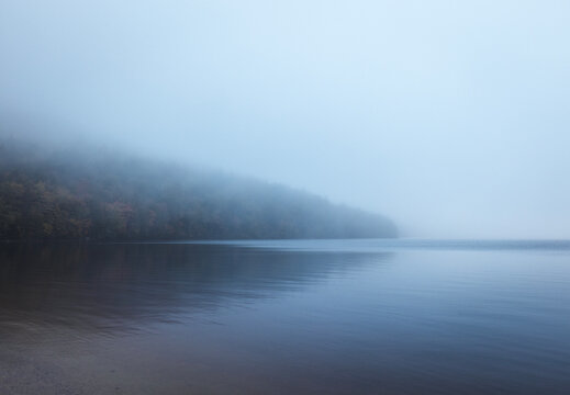 Shoreline disappears into the mist and fog, Donnell Pond, Maine