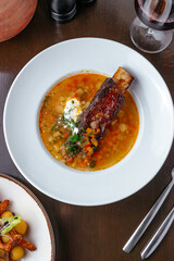 vegetable soup with beef rib in a plate