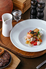 restaurant serving of fish soup