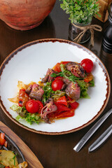 Sliced roast beef on plate on brown table