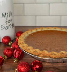 Close up of pumpkin pie with a bottle of Milk for Santa