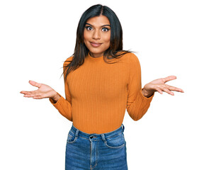 Young latin transsexual transgender woman wearing casual clothes clueless and confused expression...