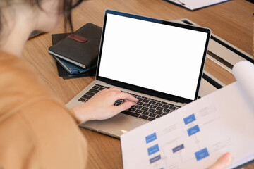 Woman using laptop with blank copy space screen for your advertisement. on the table in office