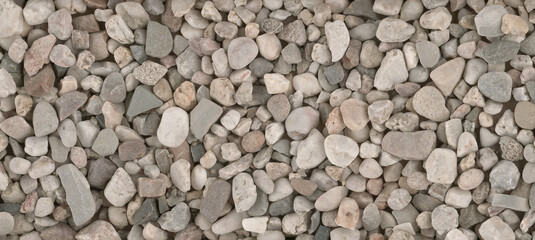 Small round stones background. Stone texture. Rough surface of small pebble stone.