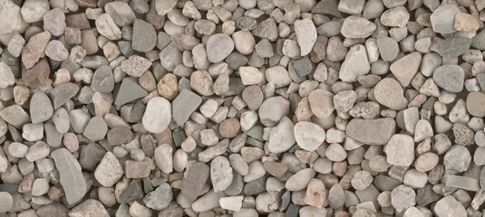 Small round stones background. Stone texture. Rough surface of small pebble stone.