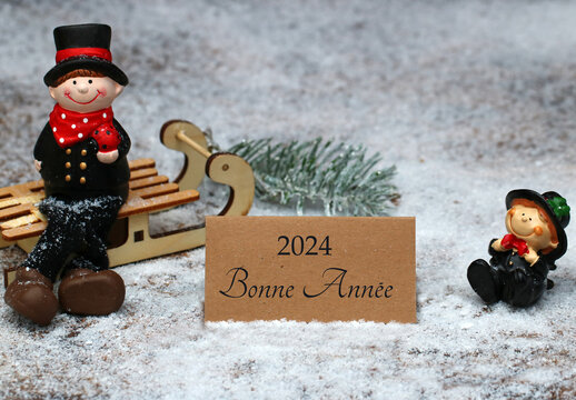 Carte de v&oelig;ux Bonne ann&eacute;e 2024&nbsp;: Deux ramoneurs dans la neige avec des v&oelig;ux pour la nouvelle ann&eacute;e sur une carte.