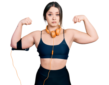 Young hispanic girl wearing sportswear doing strong gesture clueless and confused expression. doubt concept.