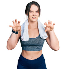 Young hispanic girl wearing sportswear and towel smiling funny doing claw gesture as cat,...