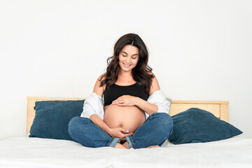 Pretty pregnant woman at home.