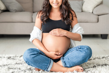 Pretty pregnant woman at home. - obrazy, fototapety, plakaty