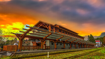 The charming Zhaoping Railway Station. Majestic wooden building exteriors, scenic cloudscapes form...