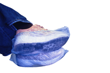 Shoes in shoe covers on a woman leg in a hospital, isolated on a white background