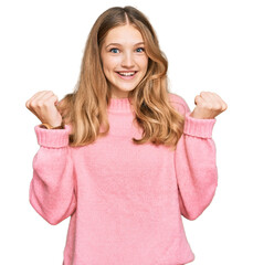 Beautiful young caucasian girl wearing casual winter sweater celebrating surprised and amazed for success with arms raised and open eyes. winner concept.