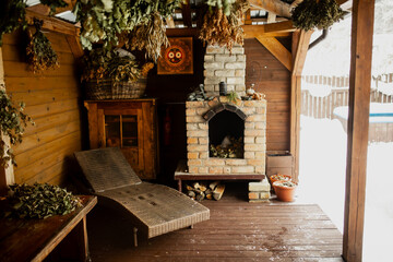 Fototapeta na wymiar Outside sauna fireplace and long chair