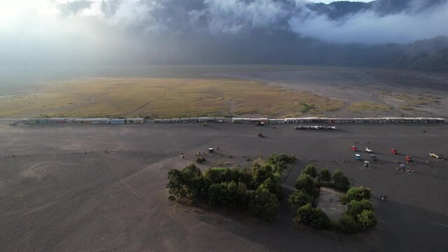 Aerial view of a huge savanna and desert with foggy mountain background