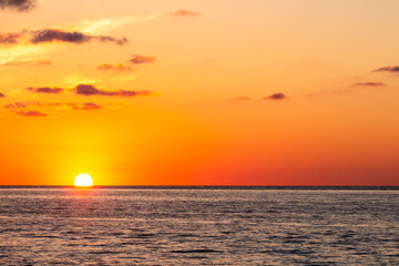 travel to Georgia - setting sun in orange sky over Black Sea water in Batumi on autumn evening