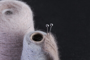 Fluffy yarn for knitting. A spool of yarn. Metal spokes are stuck into a ball of yarn. Hobby...