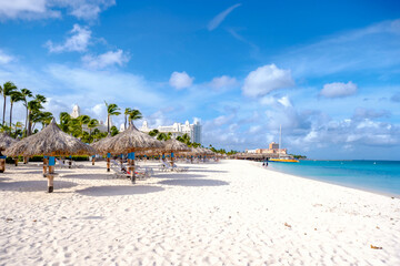 Palm Beach Aruba Caribbean white long sandy beach with palm trees at Aruba Antilles.