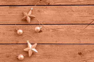 Pink Christmas decorative balloons and stars on a rustic wooden background. Waiting for the...
