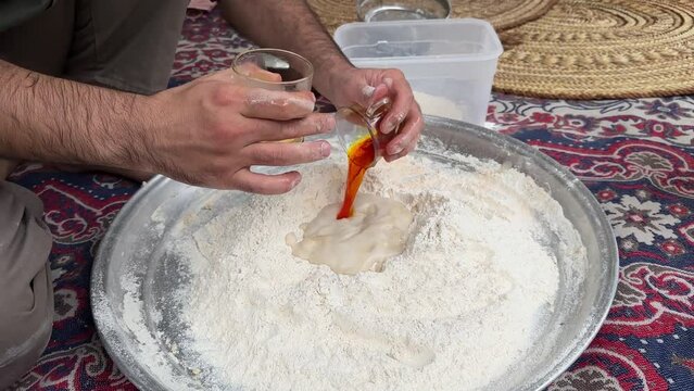 Wheat flour fermentation process to make dough and bake flat pizza bread in old brick clay oven wood fire bonfire burning in Iran a man bake bread in rural countryside village life local people Arabia
