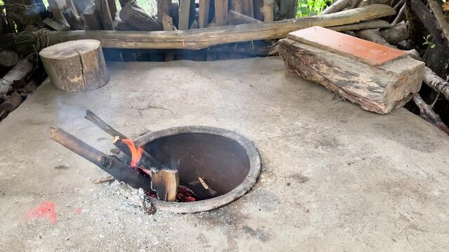 Wood fire clay ground oven in rural area in forest region in mountain countryside prepare to bake flat bread Turkish style Persian food in Iran local people life in backyard outdoor cooking delicious 