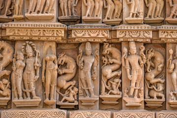 Fototapeta na wymiar The Khajuraho Group of Monuments are a group of Hindu and Jain temples Khajuraho Temple, popular worldwide for its outstanding temples designs and erotic sculpture. It is a UNESCO world Heritage site.