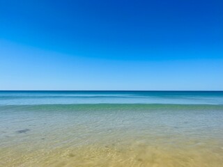 Fototapeta na wymiar Calm blue ocean horizon, clear blue sky, sea surface background