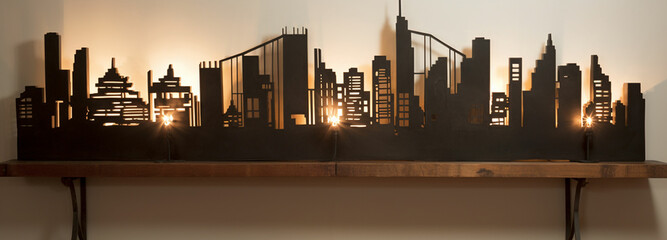 a wall art of a city skyline with lights