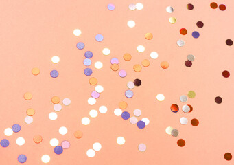 Beautiful festive peach background with confetti. Holiday 